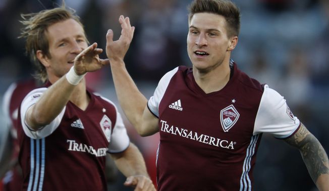 Colorado Rapids midfielder Stefan Aigner, left, congratulates midfielder Joshua Gatt after his goal against Real Salt Lake early in the first half of an MLS soccer match, Sunday, Oct. 15, 2017, in Commerce City, Colo. (AP Photo/David Zalubowski)