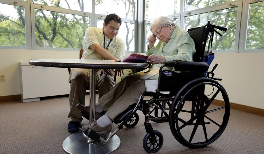 William Bazan, 20, in the HOPE program at the Hebrew Home at Riverdale, in New York, works on his reading skills with resident Selma Bachner, 90, in an atrium of the facility Thursday, May 25, 2017. The nursing home on a picturesque stretch of the Hudson River in the Bronx, has gone beyond its calling as a house for the old, playing host to the young with an innovative public high school right within its walls. She works with William on reading, helping when he stumbles on a word and cajoling him as he answers a workbook’s comprehension questions. “It makes me feel darn good to help a young person,” Bachner says. (AP Photo/Richard Drew)