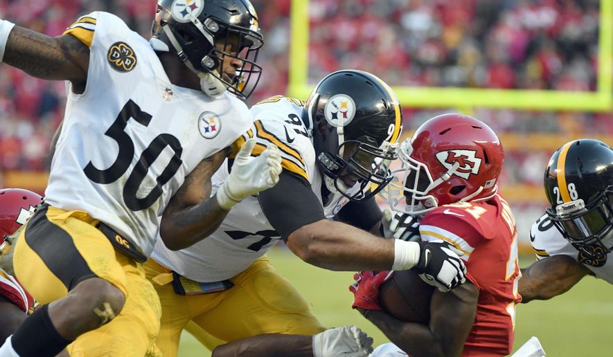 Kansas City Chiefs running back Akeem Hunt (31) is tackled by Pittsburgh Steelers defensive end Cameron Heyward (97), safety Sean Davis (28) and linebacker Ryan Shazier (50) during the second half of an NFL football game in Kansas City, Mo., Sunday, Oct. 15, 2017. (AP Photo/Ed Zurga) ** FILE **
