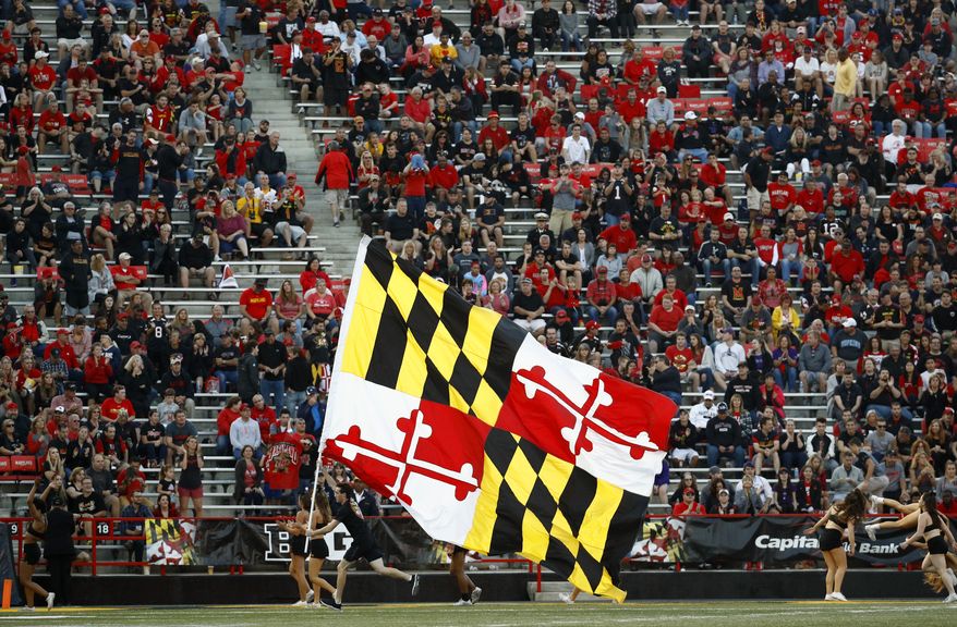 A cheerleader carries a Maryland state flag during an NCAA college football game between Maryland and Northwestern in College Park, Md., Saturday, Oct. 14, 2017. (AP Photo/Patrick Semansky) **FILE**