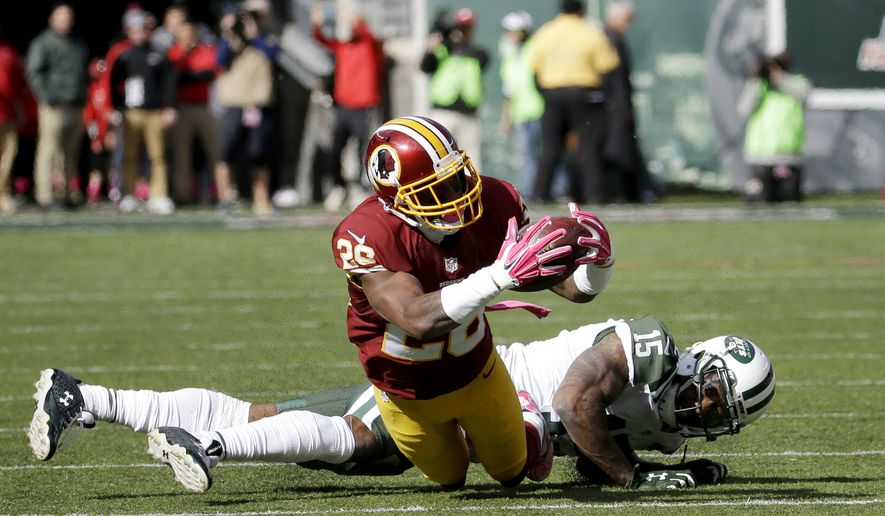File-This Oct. 18, 2015, file photo shows Washington Redskins cornerback Bashaud Breeland, front, making an interception during the first half of an NFL football game, in East Rutherford, N.J. (AP Photo/Seth Wenig, File) **FILE**