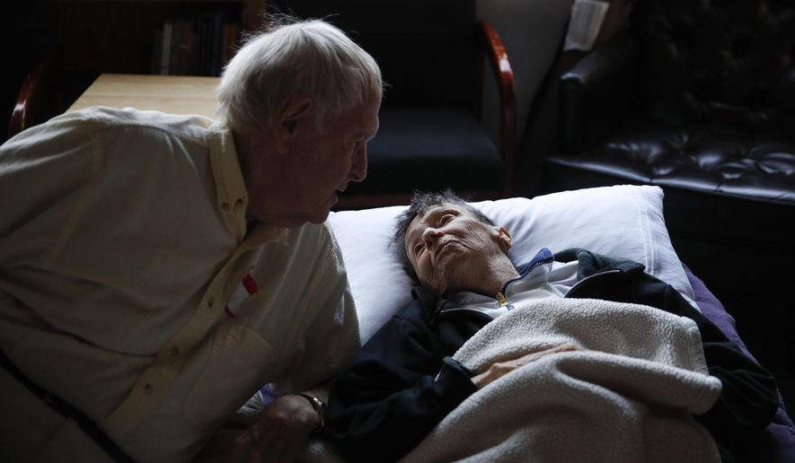 Wildfire evacuees Beatrice Thomas, 85, right, chats with her husband, Al, who is also 85, at First United Methodist Church that doubles as an evacuation shelter Sunday, Oct. 15, 2017, in Santa Rosa, Calif. "We've heard that our home is still there, but we have no confirmation of it. We can't go see it," said Beatrice. (AP Photo/Jae C. Hong)