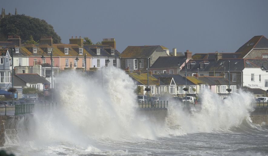 Waves break on the sea wall at Penzanze, southwestern England, as the remnants of  Hurricane Ophelia begins to hit parts of Britain and Ireland. Ireland&#x27;s meteorological service is predicting wind gusts of 120 kph to 150 kph (75 mph to 93 mph), sparking fears of travel chaos. Some flights have been cancelled, and aviation officials are warning travelers to check the latest information before going to the airport Monday.  (Ben Birchall/PA via AP)