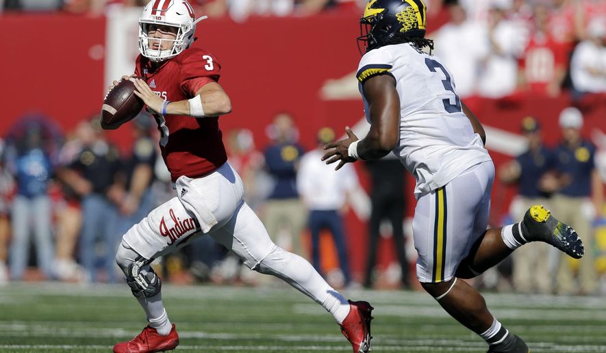 Indiana quarterback Peyton Ramsey, left, runs from Michigan defensive lineman Rashan Gary during the second half of an NCAA college football game in Bloomington, Ind., Saturday, Oct. 14, 2017. Michigan won 27-20 in overtime. (AP Photo/AJ Mast)