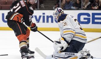 Anaheim Ducks center Chris Wagner, left, scores past Buffalo Sabres goalie Chad Johnson during the second period of an NHL hockey game in Anaheim, Calif., Sunday, Oct. 15, 2017. (AP Photo/Kyusung Gong)