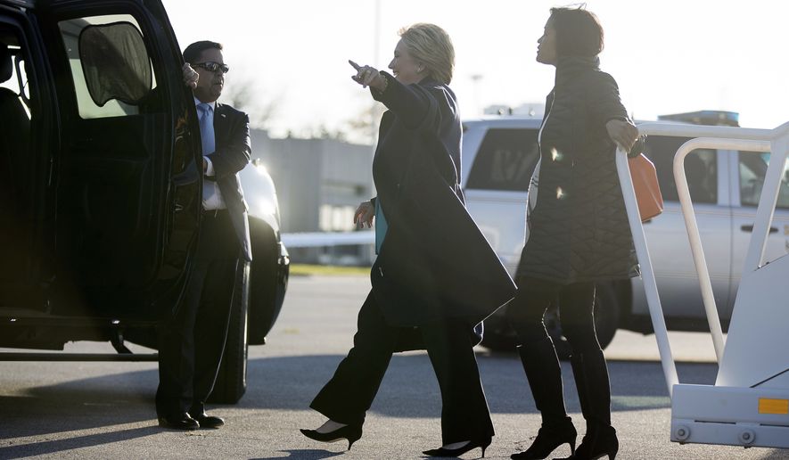 Democratic presidential candidate Hillary Clinton, center, accompanied by long time aide Cheryl Mills, right, arrives at Cleveland Burke Lakefront Airport in Cleveland, Sunday, Nov. 6, 2016. FBI Director James Comey tells Congress in a Nov. 6 letter, that a review of new Hillary Clinton emails has &quot;not changed our conclusions&quot; from earlier this year that she should not face charges. (AP Photo/Andrew Harnik)