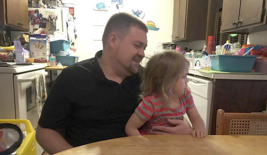 ADVANCED FOR SATURDAY, OCT. 21, 2017 Brandon Oreskovich sits with his daughter Cafourek in his Owatonna, Minn. home Saturday, Oct. 14, 2017. Oreskovich is participating in the DWI track of the Waseca and Steele counties' Drug Court program. (Deanna B. Narveson/The Free Press via AP)