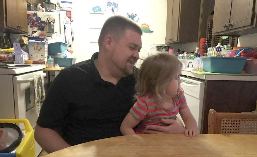 ADVANCED FOR SATURDAY, OCT. 21, 2017 Brandon Oreskovich sits with his daughter Cafourek in his Owatonna, Minn. home Saturday, Oct. 14, 2017. Oreskovich is participating in the DWI track of the Waseca and Steele counties' Drug Court program. (Deanna B. Narveson/The Free Press via AP)