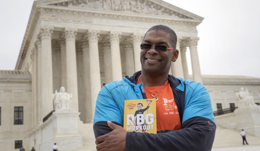 In this Oct. 13, 2017, photo, Bryant Johnson, personal trainer for Supreme Court Justice Ruth Bader Ginsburg poses in Washington, with his new book, &amp;quot;The RBG Workout: How She Stays Strong ... and You Can Too!&amp;quot; Besides the 84-year-old Ginsberg, Johnson, who now also trains Justice Stephen Breyer and Justice Elena Kagan. Johnson says he hopes the book will help convince people: “You’re never too old to do something.”  (AP Photo/J. Scott Applewhite)