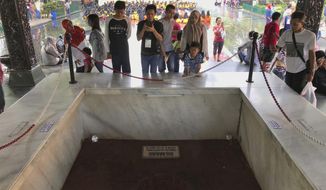 In this Sunday, Oct. 15, 2017, photo, visitors look at an old well where six Indonesian Army generals and a junior officer were buried in an abortive coup in 1965 that the military blamed on Indonesia&#39;s Communist Party and subsequently led to the anti-communist purge in 1965-1966, at Pancasila Sakti Monument in Jakarta, Indonesia. Declassified files have revealed new details of American government knowledge and support of an Indonesian army extermination campaign that killed several hundred thousand civilians during anti-communist hysteria in the mid-1960s. (AP Photo/Dita Alangkara)