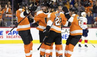 Philadelphia Flyers&#39; Sean Couturier, center left, celebrates his goal with teammates during the second period of an NHL hockey game against the Florida Panthers, Tuesday, Oct. 17, 2017, in Philadelphia. (AP Photo/Chris Szagola)