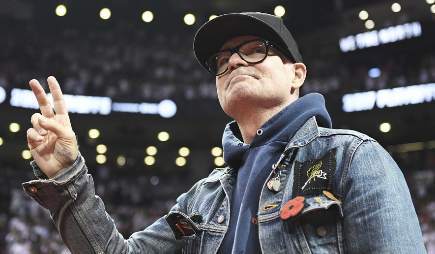 In this May 5, 2017, file photo, lead singer of The Tragically Hip Gord Downie salutes fans during the first half of Game 3 of an NBA basketball second-round playoff series between the Toronto Raptors and the Cleveland Cavaliers in Toronto. The widely revered lead singer died Tuesday night, Oct. 17, 2017. He was 53. (Frank Gunn/The Canadian Press via AP File)