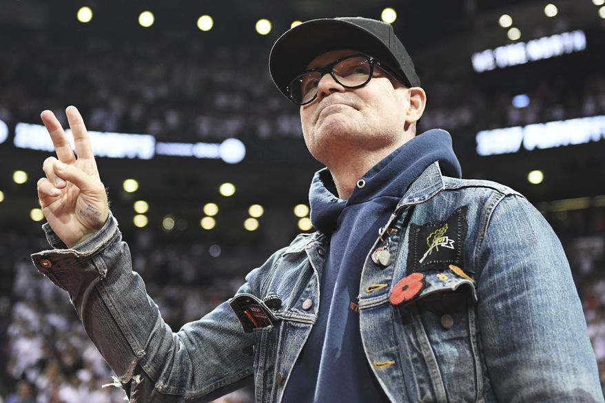 In this May 5, 2017, file photo, lead singer of The Tragically Hip Gord Downie salutes fans during the first half of Game 3 of an NBA basketball second-round playoff series between the Toronto Raptors and the Cleveland Cavaliers in Toronto. The widely revered lead singer died Tuesday night, Oct. 17, 2017. He was 53. (Frank Gunn/The Canadian Press via AP File)