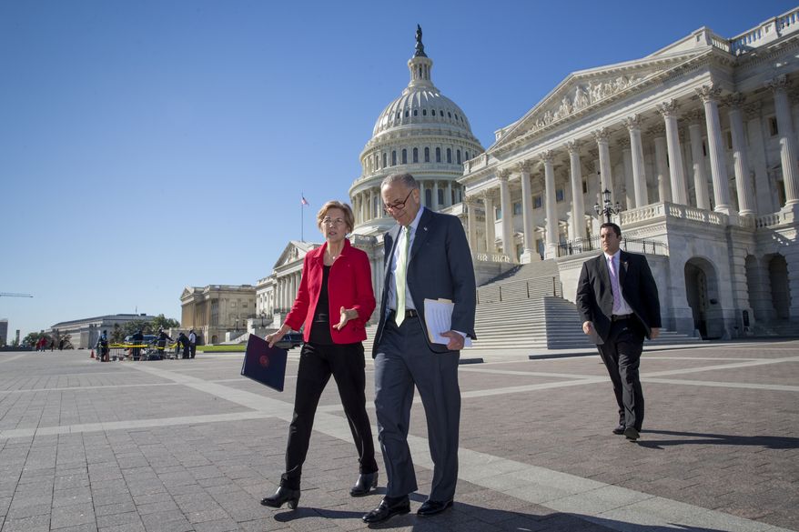 Sen. Elizabeth Warren, D-Mass., left, and Senate Minority Leader Chuck Schumer, D-N.Y., walk to a news conference on the Republican tax and budget proposals, at the Capitol in Washington, Wednesday, Oct. 18, 2017. (AP Photo/J. Scott Applewhite)
