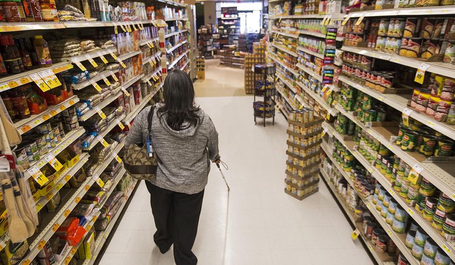 In a Wednesday, Sep. 20, 2017 photo, Carmen De Molina, who became blind five years ago from diabetes, works on walking with her cane through Ridley&#x27;s while grocery shopping with the Wyoming Independent Living class in Casper, Wyo. The class allows visually impaired individuals and people with other disabilities to practice skills which they can use to be more independent.  (Josh Galemore/The Casper Star-Tribune via AP)