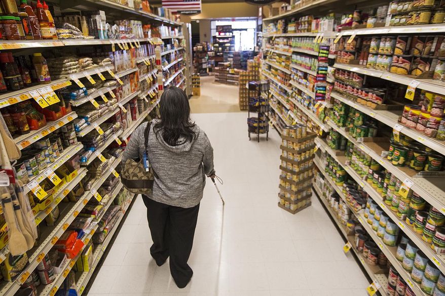 In a Wednesday, Sep. 20, 2017 photo, Carmen De Molina, who became blind five years ago from diabetes, works on walking with her cane through Ridley's while grocery shopping with the Wyoming Independent Living class in Casper, Wyo. The class allows visually impaired individuals and people with other disabilities to practice skills which they can use to be more independent. (Josh Galemore/The Casper Star-Tribune via AP)