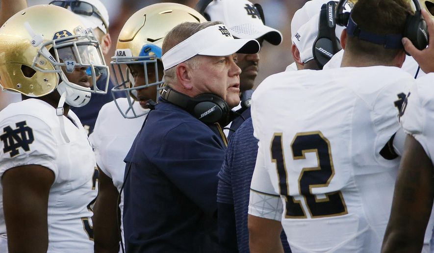 FILE - In this Sept. 16, 2017, file photo, Notre Dame head coach Brian Kelly stands with his team during the second half of an NCAA college football game against Boston College in Boston. No. 13 Notre Dame is 5-1 halfway through a crucial year for coach Kelley. Players say Kelley and the rest of the coaching staff became much more involved after last year's 4-8 debacle. (AP Photo/Michael Dwyer, File)