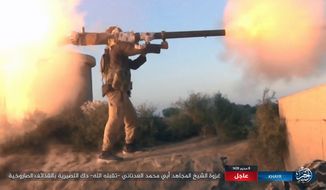 FILE - This photo posted online Thursday, Sept. 28, 2017, by supporters of the Islamic State group on an anonymous photo sharing website, purports to show an IS fighter firing a weapon during clashes with Syrian government troops in the eastern Syrian province of Deir el-Zour. While the U.S.-led coalition and Russian-backed Syrian troops have been focused on driving Islamic State from the country’s east, an al-Qaida-linked insurgent coalition known as the Levant Liberation Committee has consolidated its control over Idlib, and may be looking to return to Osama bin Laden’s strategy of attacking the West. (Militant Photo via AP, File)