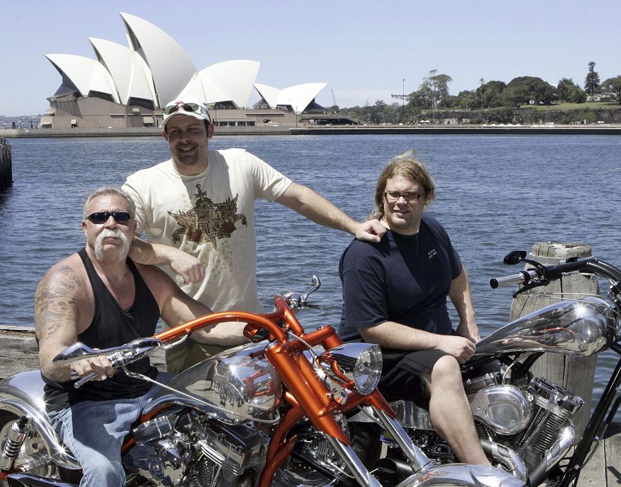 FILE - In this Feb. 15, 2007, file photo, Paul Teutul Sr. left, and sons Paul Jr. center, and Mikey from the popular reality television show "American Chopper" try out an Australian made chopper during a visit to Sydney, Australia. Discovery Channel announced on Oct. 18, 2017, it will revive the series in 2018. (AP Photo/Rob Griffith, File)
