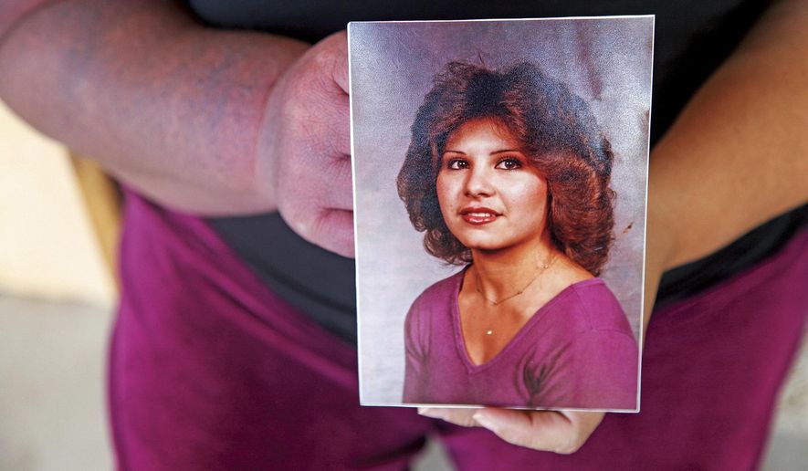 In this Friday, Sept. 29, 2017 photo, Sandra Padilla-Ramirez holds a photograph of her sister Peggy Sue Padilla at their family's home in Arroyo Seco in Espanola, N.M. Leonard Coriz, the boyfriend prosecutors say killed Padilla by running her over with his truck, claimed it was all an accident. Women are more likely to be killed by men in this state than nearly any other, according to an annual study published in Sept. 2017, by the Violence Policy Center. (Gabriela Campos/Santa Fe New Mexican via AP)