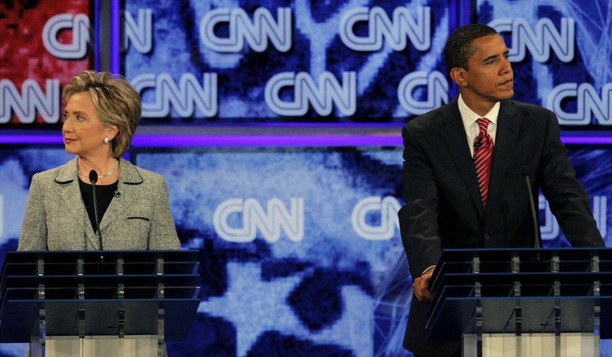 The-Democratic presidential hopefuls Sen. Hillary Rodham Clinton, D-N.Y., left, and Sen. Barack Obama, D-Ill., listen during a debate at the University of Nevada in Las Vegas, in this Thursday, Nov. 15, 2007, file photo. (AP Photo/Jae C. Hong) ** FILE **