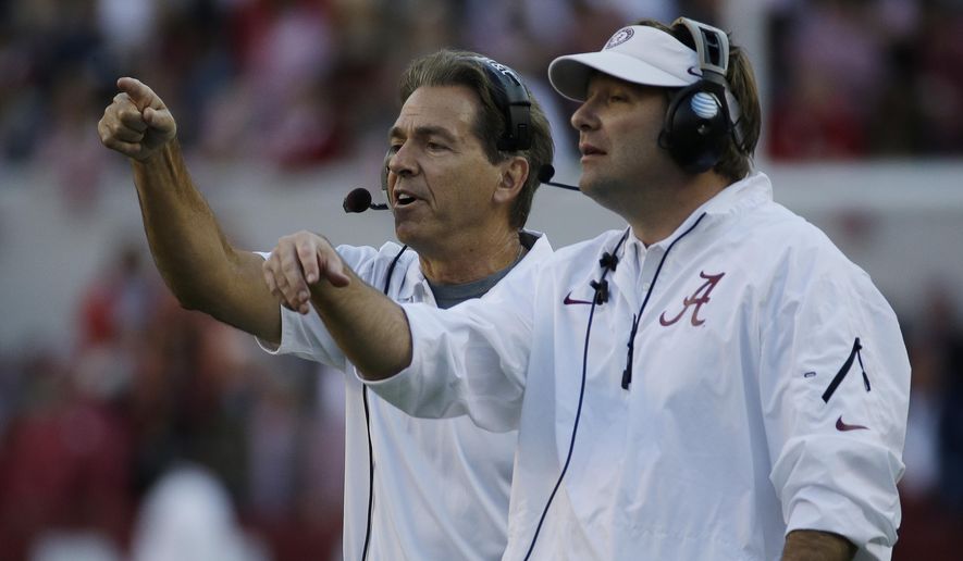 FILE - In this Oct. 26, 2013, file photo, Alabama head coach Nick Saban, left, and then-defensive coordinator Kirby Smart call in a defense during the second half of an NCAA college football game against Tennessee, in Tuscaloosa, Ala. Kirby Smart has Georgia on a clear path for a showdown with Nick Saban, his mentor at Alabama. (AP Photo/Dave Martin, File)