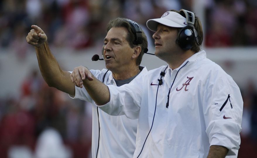 FILE - In this Oct. 26, 2013, file photo, Alabama head coach Nick Saban, left, and then-defensive coordinator Kirby Smart call in a defense during the second half of an NCAA college football game against Tennessee, in Tuscaloosa, Ala. Kirby Smart has Georgia on a clear path for a showdown with Nick Saban, his mentor at Alabama. (AP Photo/Dave Martin, File)