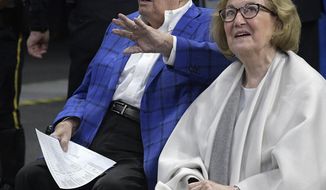 FILE - In this Wednesday, March 8, 2017, file photo, Orlando Magic owner Rich DeVos, left, waves to fans while watching court side with his wife Helen during the first half of an NBA basketball game against the Chicago Bulls in Orlando, Fla. The family of Helen DeVos said the philanthropist from western Michigan known for her support of children&#39;s health, Christian education and the arts has died. She was 90. Her family said she died Wednesday, Oct. 18, of complications from a stroke following a recent diagnosis of myeloid leukemia. (AP Photo/Phelan M. Ebenhack, File)