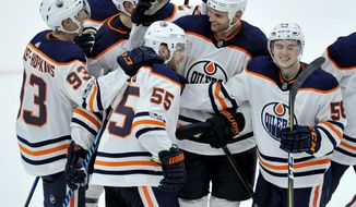 Edmonton Oilers&#39; Mark Letestu (55) celebrates with teammates after scoring against the Chicago Blackhawks in overtime of an NHL hockey game Thursday, Oct. 19, 2017, in Chicago. The Oilers own 2-1. (AP Photo/Paul Beaty)