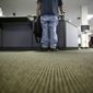 In this Friday, March 10, 2017, file photo, a lone job seeker checks in at the front desk of the Texas Workforce Solutions office in Dallas. (AP Photo/LM Otero, File)