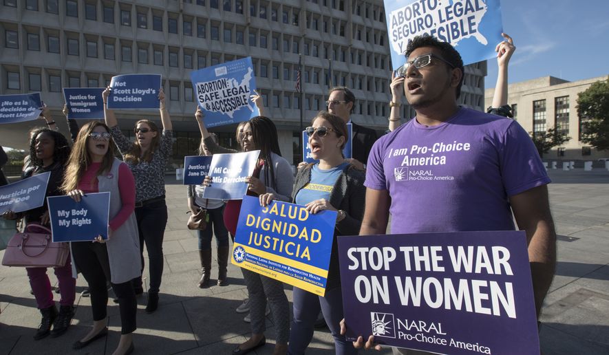 Activists with Planned Parenthood demonstrated in Washington on Oct. 20, 2017, in support of a pregnant 17-year-old being held in a Texas facility for unaccompanied immigrant children to obtain an abortion. (Associated Press) **FILE**