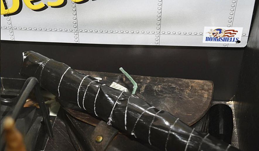In this undated photo released by the Pinellas County Sheriff's Office, an improvised explosive device is shown in the home of Randall Drake. Sheriff's deputies conducting a child porn raid on the home found an arsenal of guns and explosives and a homemade silencer, along with a note promising "bloody revenge." Pinellas County Sheriff Bob Gualtieri told reporters Thursday night, Oct. 19, 2017, deputies also found aerial images of two schools and a water plant in nearby Tampa. There was also a note that deputies believe Drake wrote, promising he'll have his "bloody revenge" and "the world will burn burn." (Pinellas County Sheriff's Office via AP)