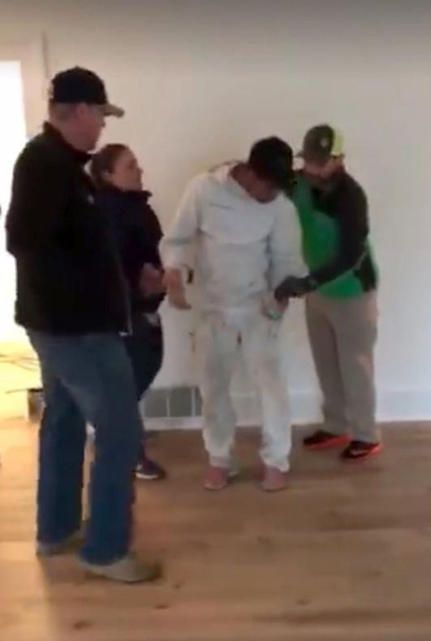 This Thursday, Oct. 19, 2017 photo taken from video provided by George Cardenas shows federal immigration agents arresting a worker even though they acknowledged they lacked a warrant to enter the home near Beaverton, Ore. U.S. Immigration and Customs Enforcement says it's now investigating the incident. The agency said the arrested man whose name wasn't provided has been released. Spokeswoman Yasmeen Pitts O'Keefe said the matter has also been referred to watchdog groups both within ICE and in its parent department in Washington. (George Cardenas via AP)