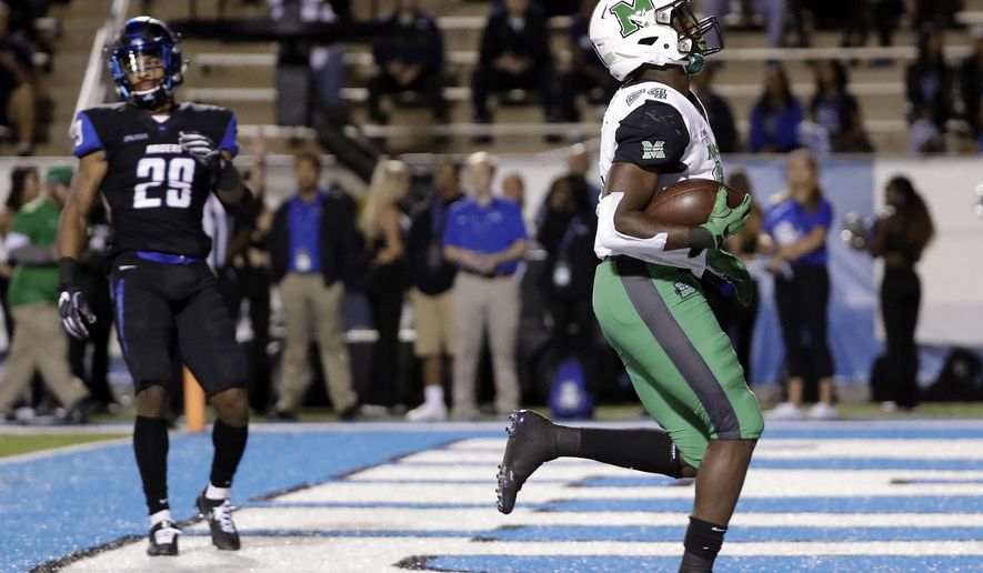 Marshall running back Keion Davis (24) scores a touchdown ahead of Middle Tennessee cornerback Darryl Randolph (29) in the first half of an NCAA college football game Friday, Oct. 20, 2017, in Murfreesboro, Tenn. (AP Photo/Mark Humphrey)