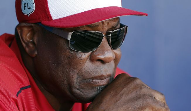 FILE - In this March 11, 2017, file photo, Washington Nationals manager Dusty Baker talks to reporters in the dugout before playing New York Mets in a spring training baseball game in Port St. Lucie, Fla. The Nationals announced Friday, Oct. 20, 2017, that Baker won&#x27;t be back next season. Baker led the Nationals to the NL East title in each of his two years with the club. But Washington lost its NL Division Series both times. (AP Photo/John Bazemore, File)