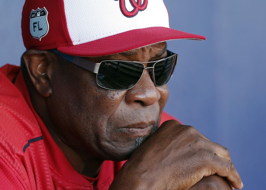 FILE - In this March 11, 2017, file photo, Washington Nationals manager Dusty Baker talks to reporters in the dugout before playing New York Mets in a spring training baseball game in Port St. Lucie, Fla. The Nationals announced Friday, Oct. 20, 2017, that Baker won&#x27;t be back next season. Baker led the Nationals to the NL East title in each of his two years with the club. But Washington lost its NL Division Series both times. (AP Photo/John Bazemore, File)