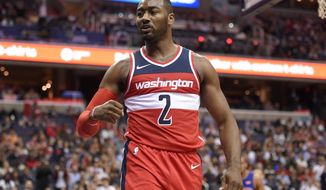 Washington Wizards guard John Wall (2) reacts during the second half of an NBA basketball game against the Detroit Pistons, Friday, Oct. 20, 2017, in Washington. The Wizards won 115-111. (AP Photo/Nick Wass)