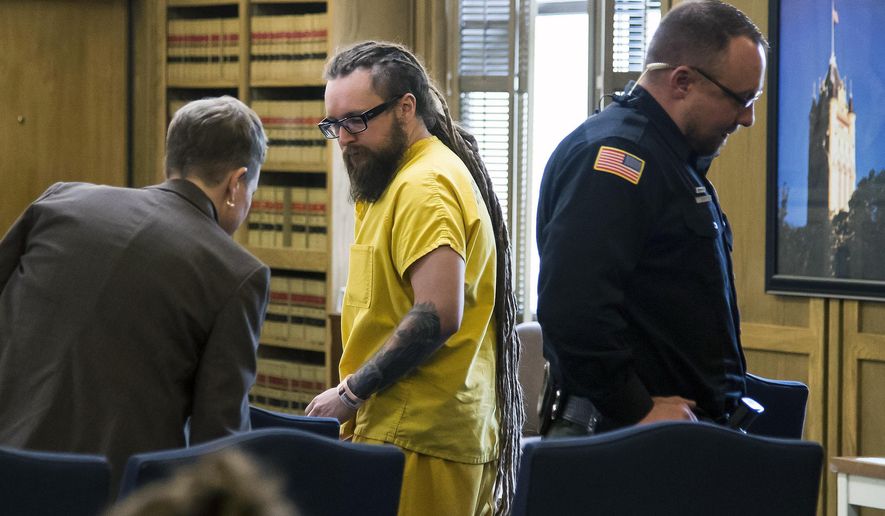 Rafal Piotrowski, 31, a member of the Polish metal band Decapitated, appears before Superior Court Judge John Cooney, Friday, Oct. 20, 2017, in Spokane, Wash. The final two members of the Polish metal band Decapitated had bail set at $100,000 each Friday on rape and kidnapping charges after they were arrested for the gang-rape of a woman on their tour bus following a show last summer. (Colin Mulvany/The Spokesman-Review via AP)