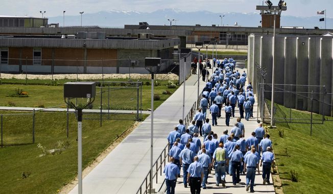 FILE - In this June 15, 2010 file photo, inmates walk to the dinning hall from their cell block at the Idaho State Correctional Institution outside Boise, Idaho. A federal judge says the Idaho Department of Prisons was in contempt of court for a time for failing to follow court orders designed to improve health care for inmates, but the problems appear to have been fixed. The ruling means the state doesn&#x27;t face any punitive fines for now. More importantly, it means the judge isn&#x27;t currently planning on extending the amount of time that health care at the Idaho State Correctional Institution remains under federal court oversight. (AP Photo/Charlie Litchfield, File)
