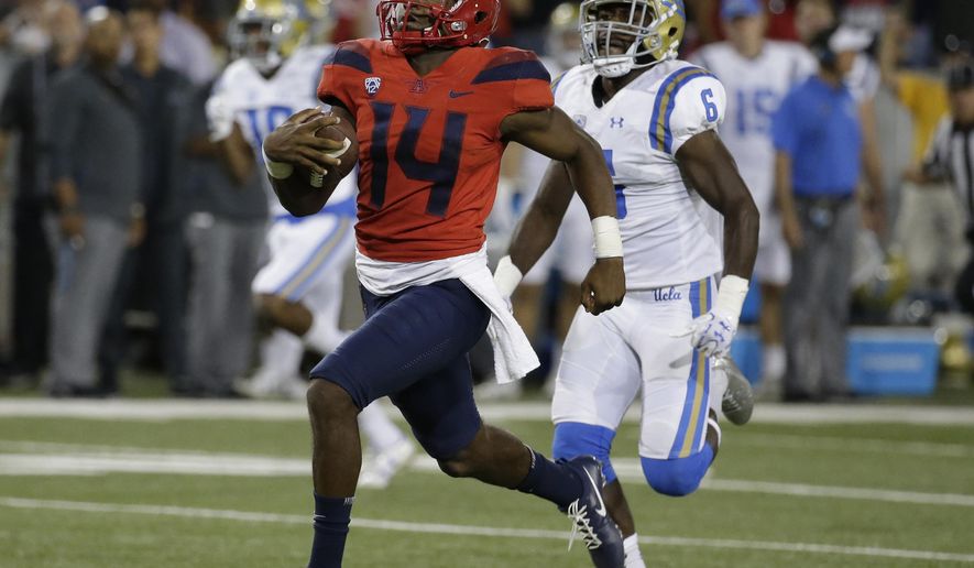 Arizona quarterback Khalil Tate (14) runs for a touchdown against UCLA during the second half ofp an NCAA college football game, Saturday, Oct. 14, 2017, in Tucson, Ariz. Arizona defeated UCLA 47-30. (AP Photo/Rick Scuteri)