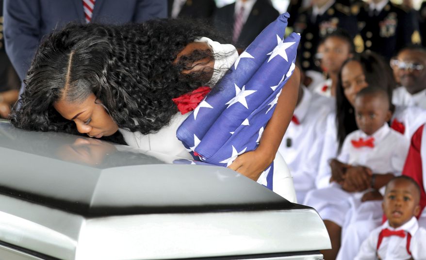 Myeshia Johnson, the wife of Army Sgt. La David Johnson, kisses her husband&#39;s casket during his funeral service at the Hollywood Memorial Gardens in Hollywood, Fla., on Saturday, Oct. 21, 2017. Sgt. Johnson was killed with three other colleagues in an ambush by extremists in Niger on Oct. 4. (Mike Stocker/South Florida Sun-Sentinel via AP)