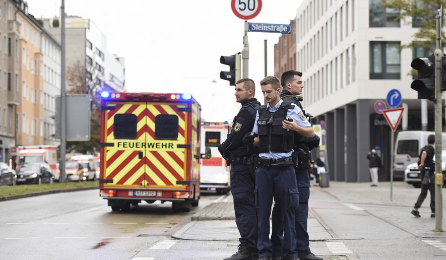 Police guard the area at Rosenheimer Platz square in Munich, Germany, Saturday, Oct. 21, 2017. Police say a man with a knife has lightly wounded several people in Munich. Officers are looking for the assailant. Munich police called on people in the Rosenheimer Platz square area, located close to the German city's downtown, to stay inside after the incident on Saturday morning. (Andreas Gebert/dpa via AP)