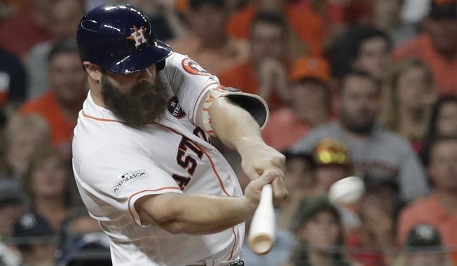Houston Astros&#x27; Evan Gattis hits a home run during the fourth inning of Game 7 of baseball&#x27;s American League Championship Series against the New York Yankees Saturday, Oct. 21, 2017, in Houston. (AP Photo/David J. Phillip) **FILE**