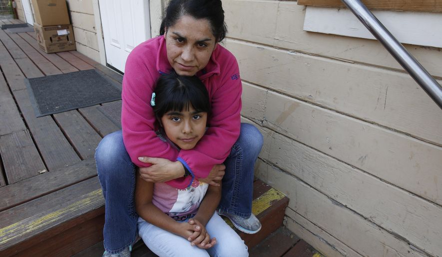Wilma Illanes and her daughter Gabriela Cervantes, 8, pose Wednesday, Oct. 18, 2017, in Sonoma, Calif. Illanes and her family had to evacuate from there home as a massive wildfire swept through the area last week. While their home was sparred, Illanes, who is a baby sitter, and her husband, who is a landscaper, were both out of work for a work causing them to seek assistance due to the hardship. AP Photo/Rich Pedroncelli)