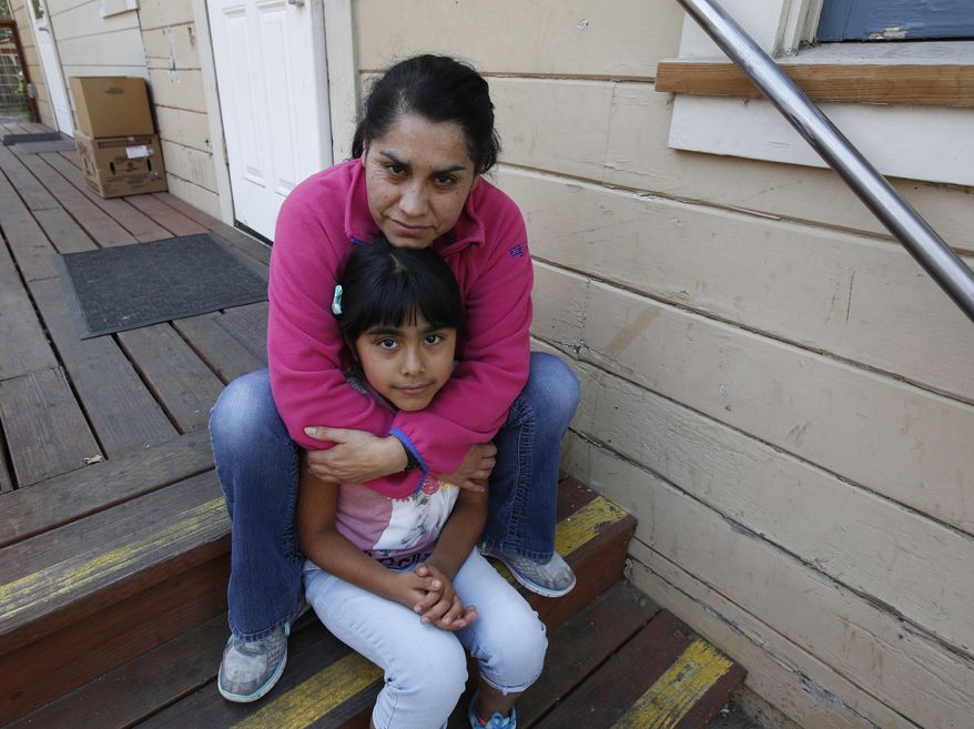 Wilma Illanes and her daughter Gabriela Cervantes, 8, pose Wednesday, Oct. 18, 2017, in Sonoma, Calif. Illanes and her family had to evacuate from there home as a massive wildfire swept through the area last week. While their home was sparred, Illanes, who is a baby sitter, and her husband, who is a landscaper, were both out of work for a work causing them to seek assistance due to the hardship. AP Photo/Rich Pedroncelli)