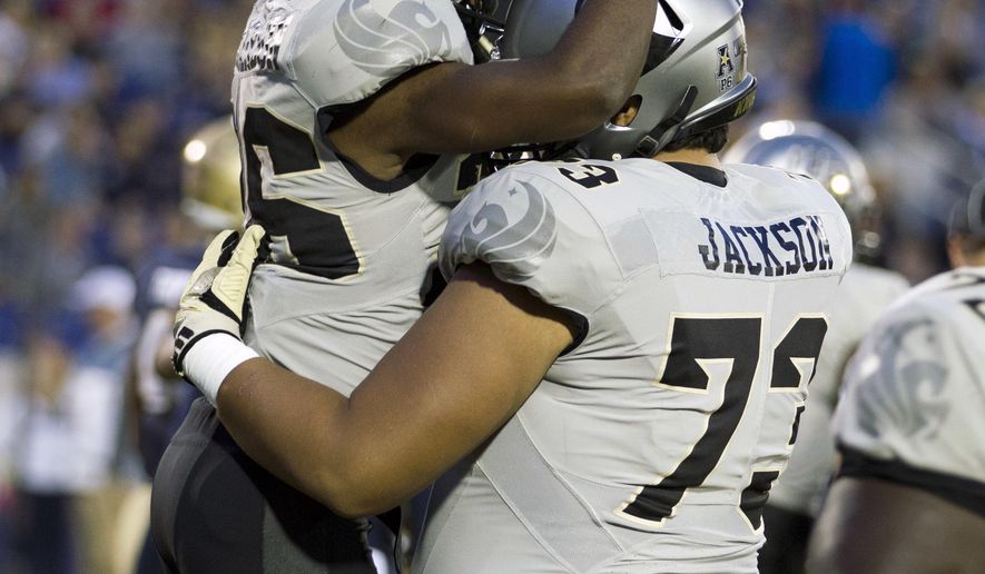 Central Florida wide receiver Otis Anderson (26) celebrates with his teammate after scoring a touchdown during the first half of an NCAA college football game against Navy in Annapolis, Md., Saturday, Oct. 21, 2017. (AP Photo/Jose Luis Magana)