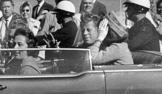 In this Nov. 22, 1963 file photo, President John F. Kennedy waves from his car in a motorcade in Dallas. Riding with Kennedy are First Lady Jacqueline Kennedy, right, Nellie Connally, second from left, and her husband, Texas Gov. John Connally, far left.  President Donald Trump, on Saturday, Oct. 21, 2017,  says he plans to release thousands of never-seen government documents related to President John F. Kennedy&#39;s assassination.  (AP Photo/Jim Altgens, File)