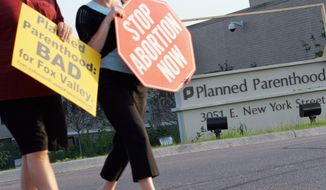 Protesters march near a Planned Parenthood location in Aurora, Ill., on Sept. 18, 2007. (Associated Press) **FILE**