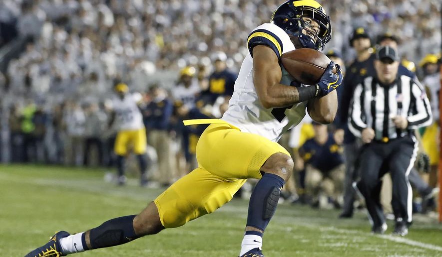 Michigan's Kekoa Crawford (1) hauls in a catch against Penn State during the first half of an NCAA college football game in State College, Pa., Saturday, Oct. 21, 2017. (AP Photo/Chris Knight)
