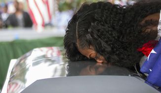 In this Saturday, Oct. 21, 2017, file photo, Myeshia Johnson kisses the casket of her husband, Sgt. La David Johnson during his burial service at Fred Hunter&#39;s Hollywood Memorial Gardens in Hollywood, Fla. (Matias J. Ocner/Miami Herald via AP, File)